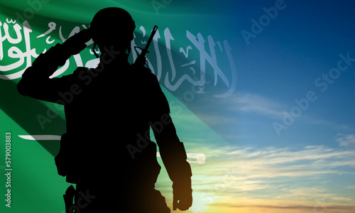 Silhouette of a saluting soldier against the sky and Saudi Arabia flag. Concept - Armed Force of Saudi Arabia. EPS10 vector