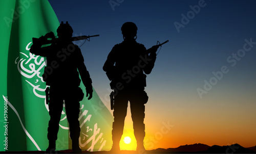 SIlhouettes of a soldiers against the sunset sky and Saudi Arabia flag. Concept - Armed Force of Saudi Arabia. National Holidays background. EPS10 vector