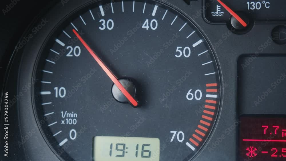 Odometer counter is device for measuring number of revolutions of a vehicle wheel. The red arrow on the dashboard of the car shows numbers and moves up and down, close-up front view. Odometer counter is device for measuring number of revolutions of a vehicle wheel. The red arrow on the dashboard of the car shows numbers and moves up and down, close-up front view.