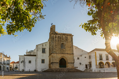 Downtown of Faro with Se Cathedral in the morning with orange tree in the foreground, Portugal