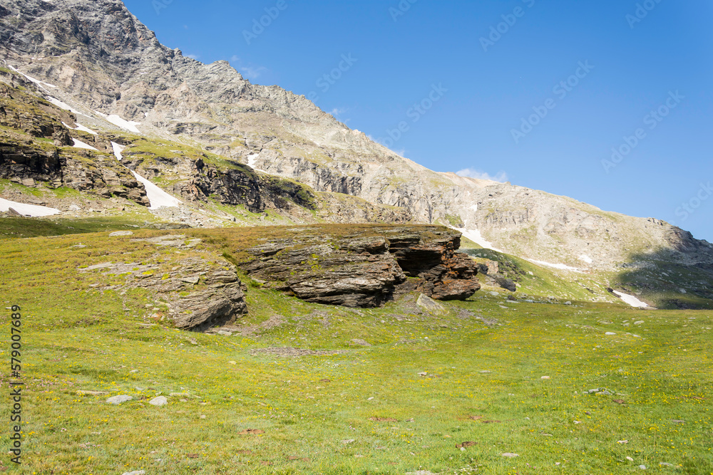 Mountain landscape in summer, the sky is blue with soft clouds. This was a hike in the Alps to Mount Cenis Lake