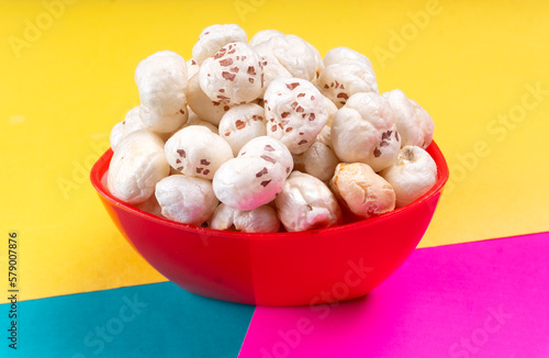 Organic Crispy Lotus pops Seeds or Phool Makhana served in a wooden bowl on background.