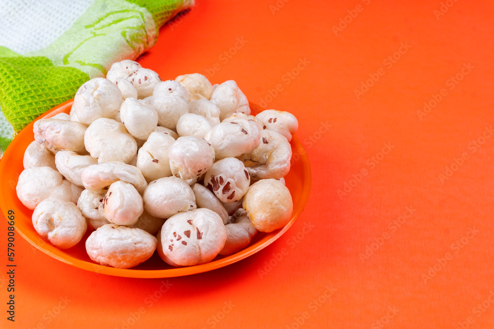 Organic Crispy Lotus pops Seeds or Phool Makhana served in a wooden bowl on background. Organic Crispy Lotus pops Seeds or Phool Makhana served in a wooden bowl on background.