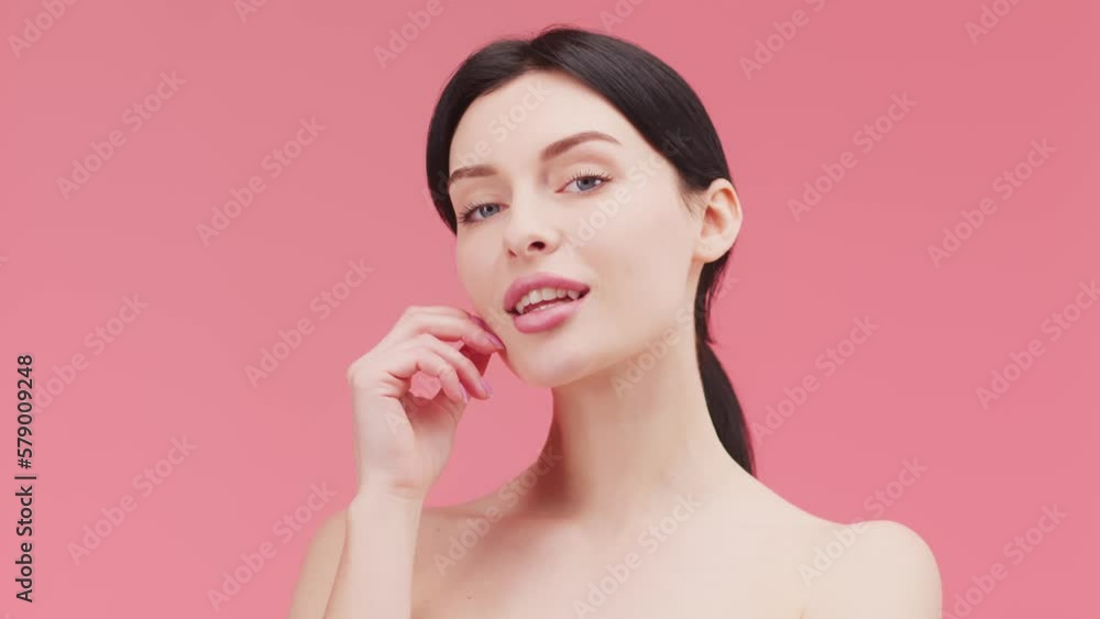 Beauty woman face isolated on pink background. Skin care. Beautiful female model with perfect clean fresh skin Beauty woman face isolated on pink background. Skin care. Beautiful female model with perfect clean fresh skin