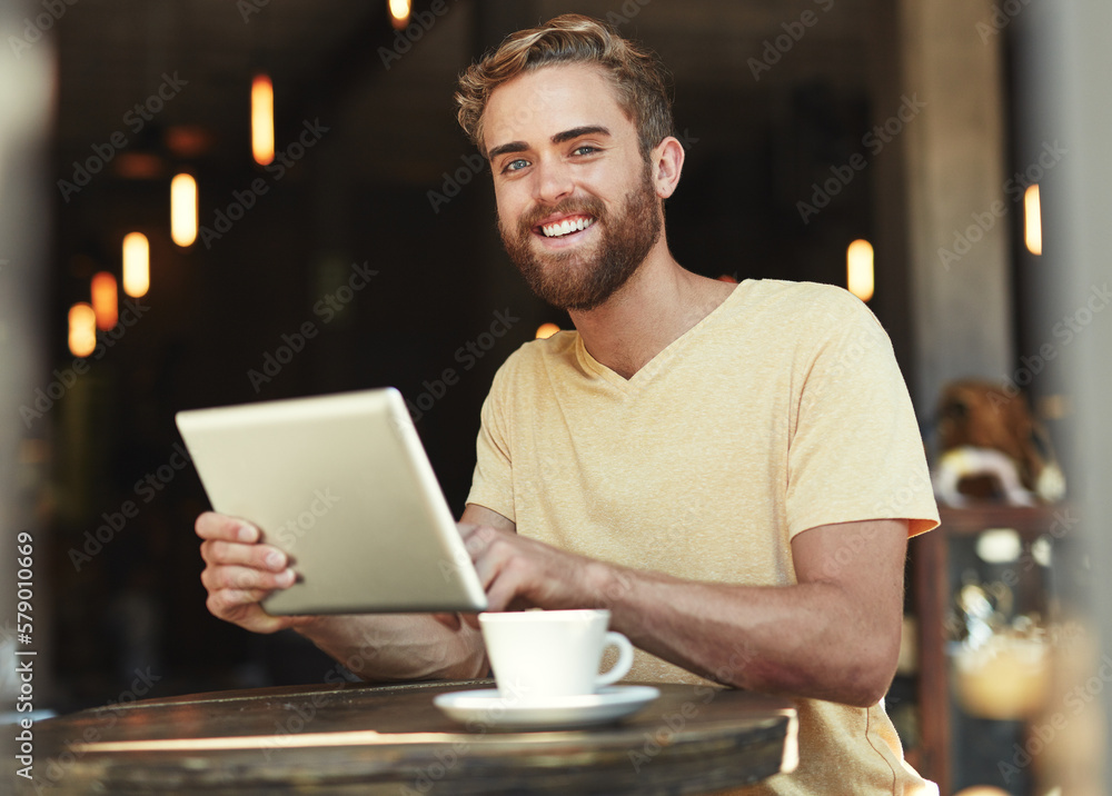 Whats happening on social media. Portrait of a young man using a digital tablet in a cafe. Whats happening on social media. Portrait of a young man using a digital tablet in a cafe.