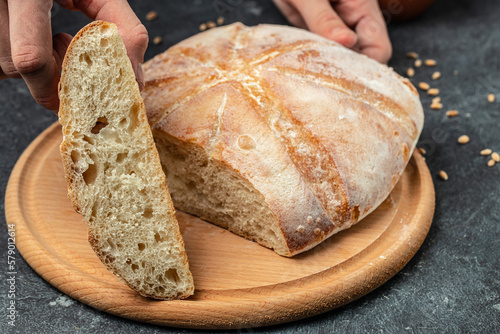 Female hands holding Homemade sourdough bread. Culinary, cooking, bakery concept