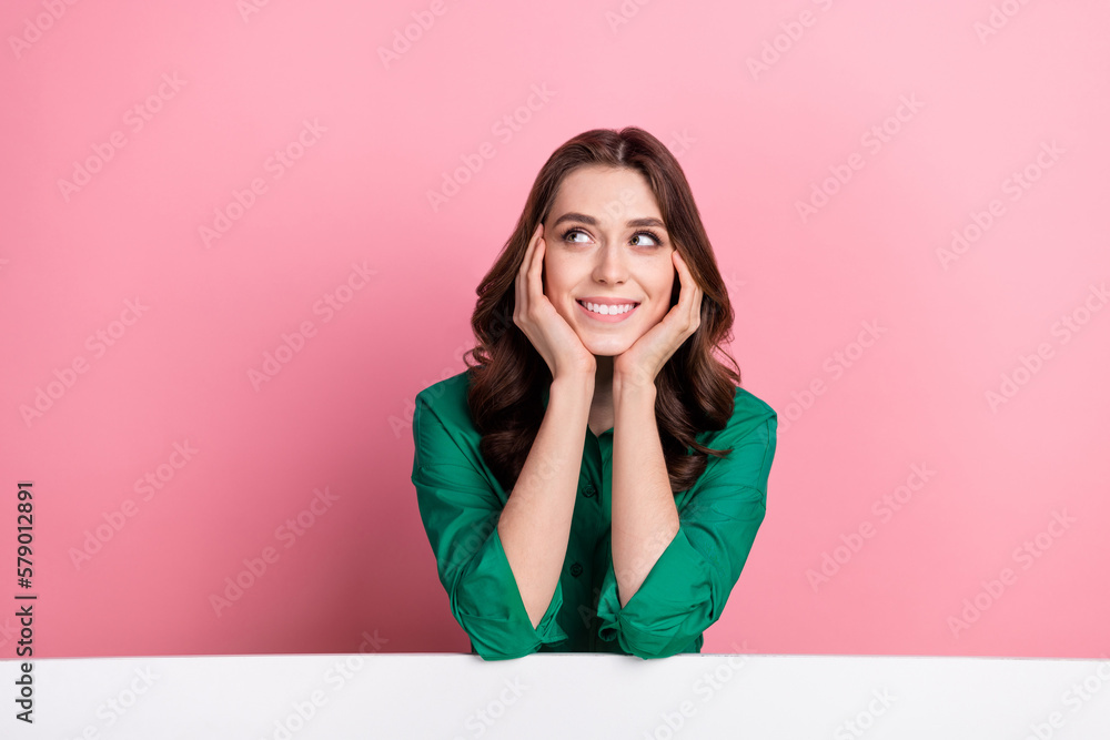 Photo of dreamy cute lady dressed green blouse arms cheeks looking emtpy space isolated pink color background Photo of dreamy cute lady dressed green blouse arms cheeks looking emtpy space isolated pink color background