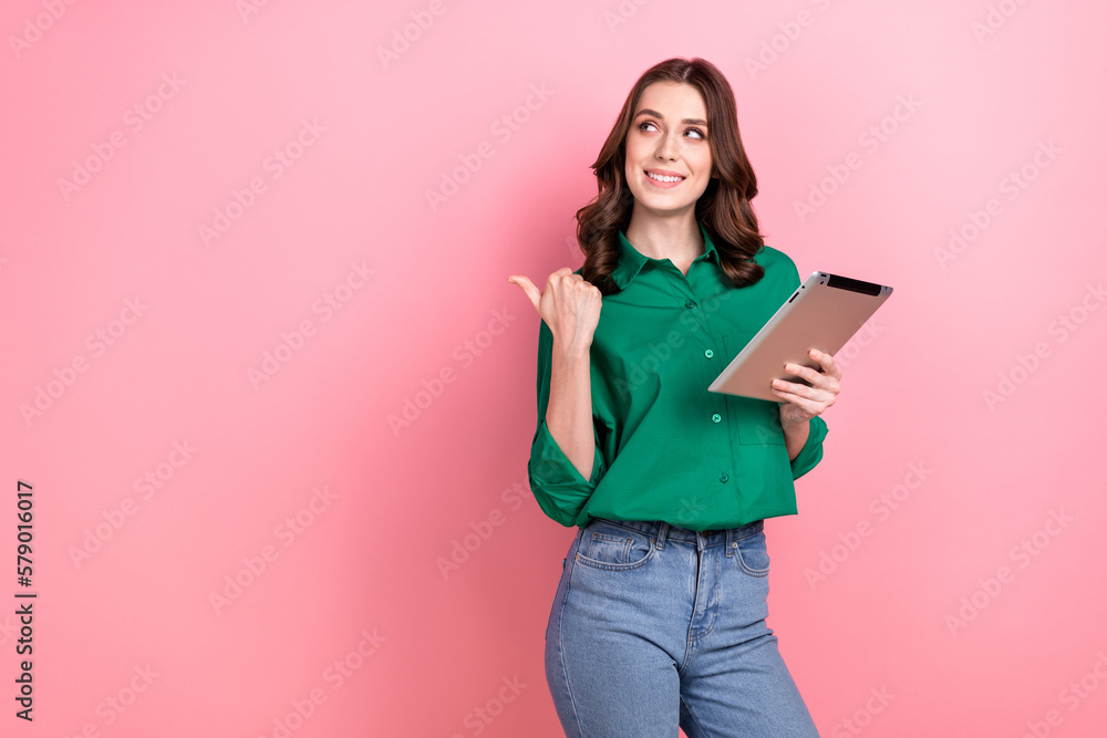 Portrait of positive cheerful hr recruiter girl hold tablet look direct finger empty space isolated on pink color background Portrait of positive cheerful hr recruiter girl hold tablet look direct finger empty space isolated on pink color background