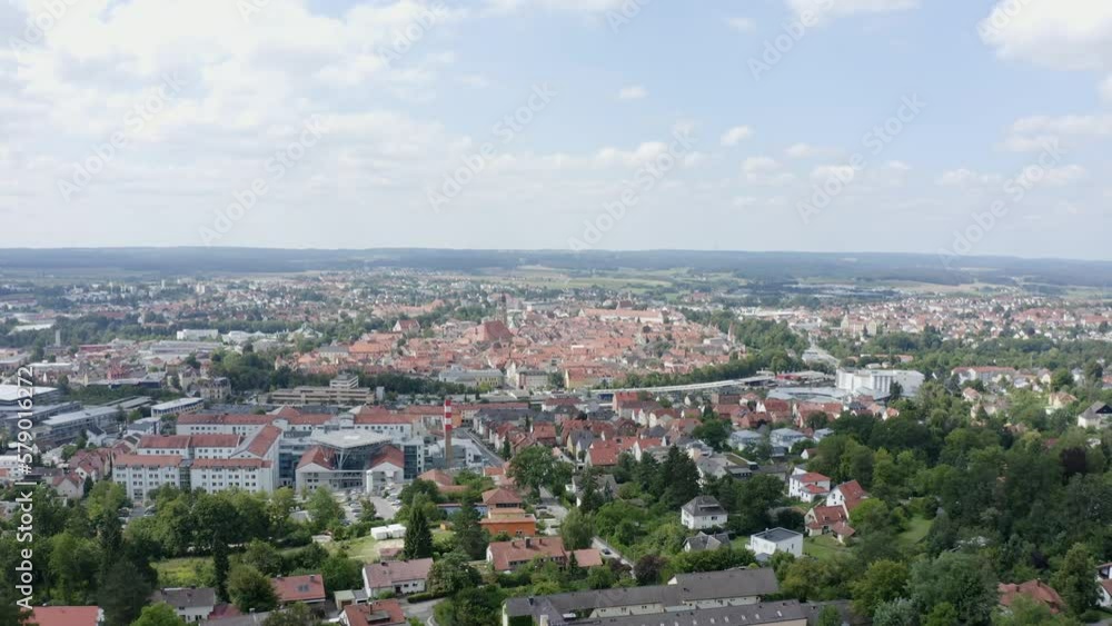 Drone shot over a city mid day with old buildings and trees inbetween Drone shot over a city mid day with old buildings and trees inbetween