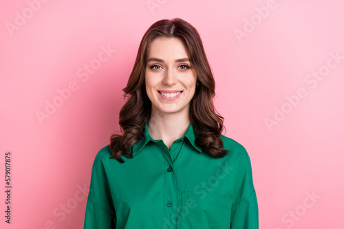 Portrait of cheerful positive lovely cute girl with curly hairstyle wear green shirt toothy smiling dental ad isolated on pink background © deagreez