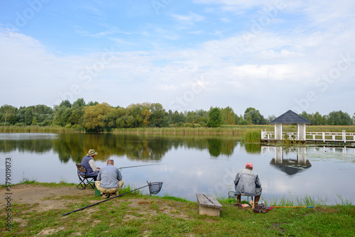 Anglers are fishing with fishing rod on lake. Lifestyle