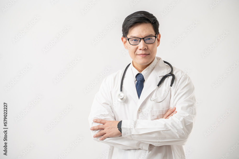 Portrait of confident Asian Doctor in glasses with stethoscope standing with arms crossed on white background Portrait of confident Asian Doctor in glasses with stethoscope standing with arms crossed on white background