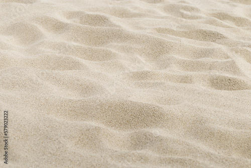 Beige Sand texture natural background. Close up waves pattern on sand dunes  light pastel color  minimal nature backdrop  beautiful beach. Summer and travel  spa and relax concept. Selective focus.