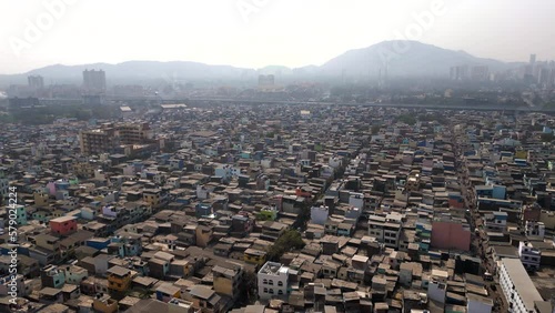 Aerial view of residential buildings in the crowded Govandi neighbourhood in the the suburbs of Mumbai, Maharashtra, India, population growth, poverty and overpopulation concept. photo