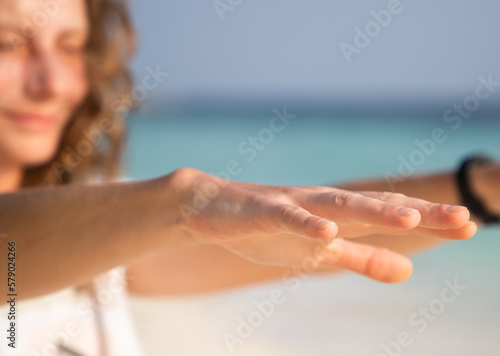woman doing qigong on beach