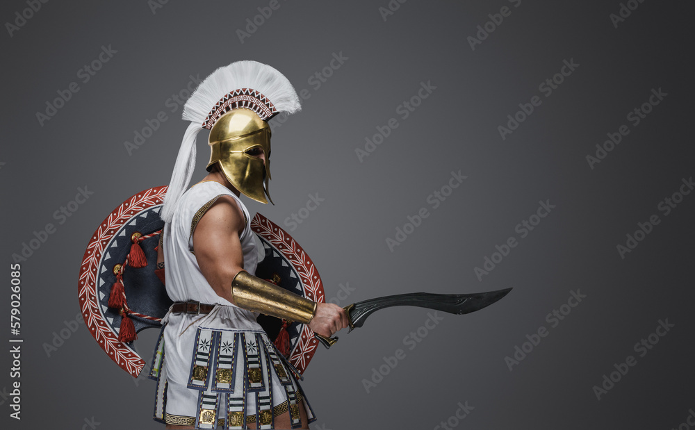 Portrait of attacking soldier from antique greece dressed in white tunic and armor.
