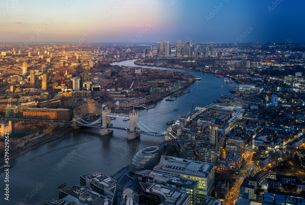 Seamless sunset to night time lapse view of the skyline of London with Tower Bridge and Thames River until Canary Wharf, England
