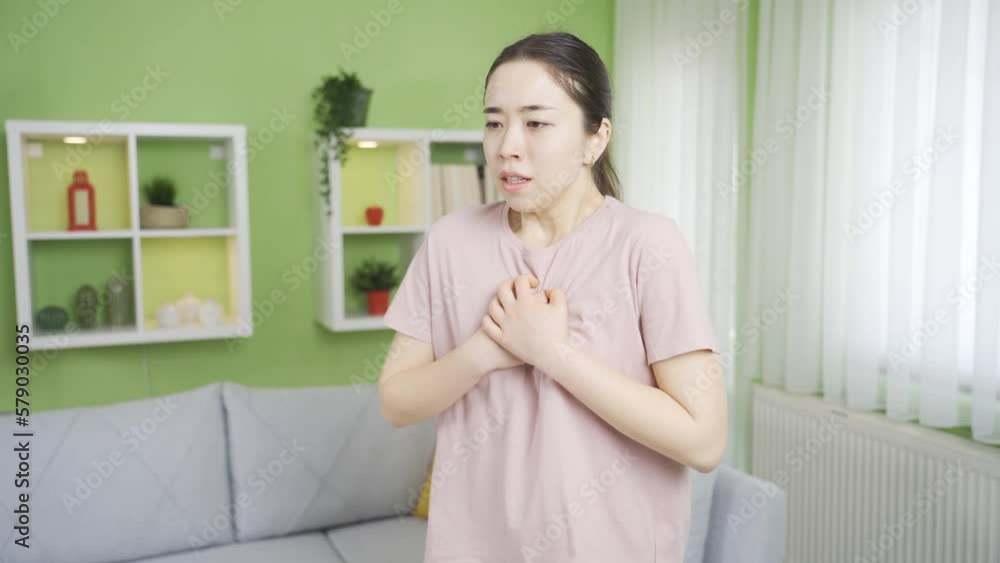 Close-up asian young woman with COPD unable to breathe and hurts due to chest pain and tightness. Close-up asian young woman with COPD unable to breathe and hurts due to chest pain and tightness.