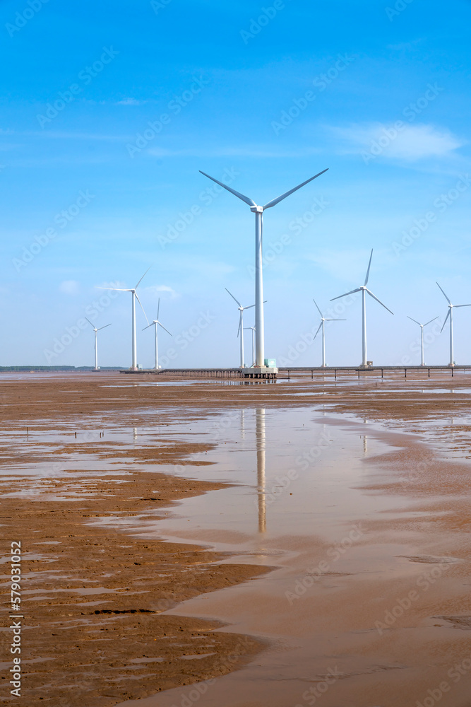 Seascape with Turbine Green Energy Electricity, Windmill for electric power production, wind turbines generating electricity on the sea at Bac Lieu province, Vietnam