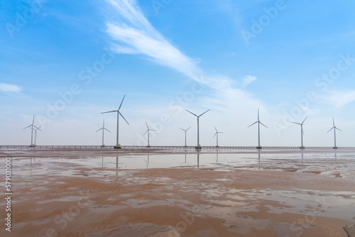 Seascape with Turbine Green Energy Electricity, Windmill for electric power production, wind turbines generating electricity on the sea at Bac Lieu province, Vietnam photo