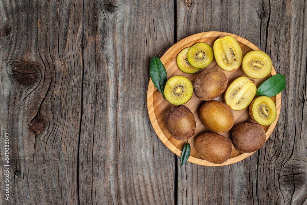 Closeup ripe golden kiwi fruit on wooden background. Healthy fruits concept. place for text, top view