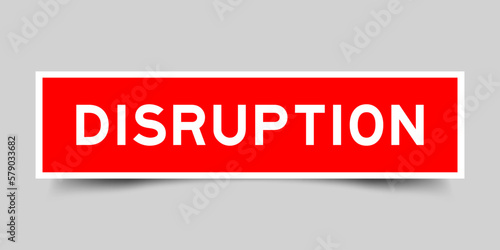 Red color square shape sticker label with word disruption on gray background