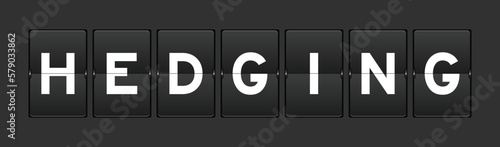 Black color analog flip board with word hedging on gray background