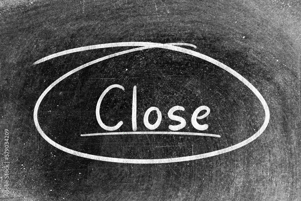 White chalk hand writing in word close and circle shape on blackboard background