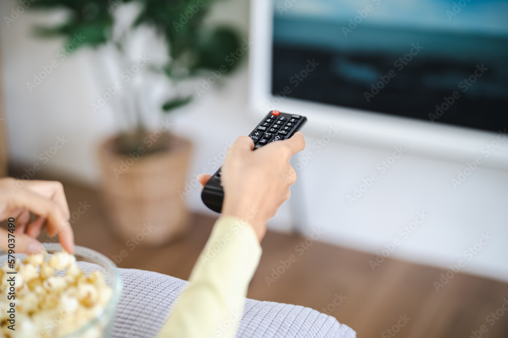 Asian woman Watching smart TV and using remote controller Hand holding ...