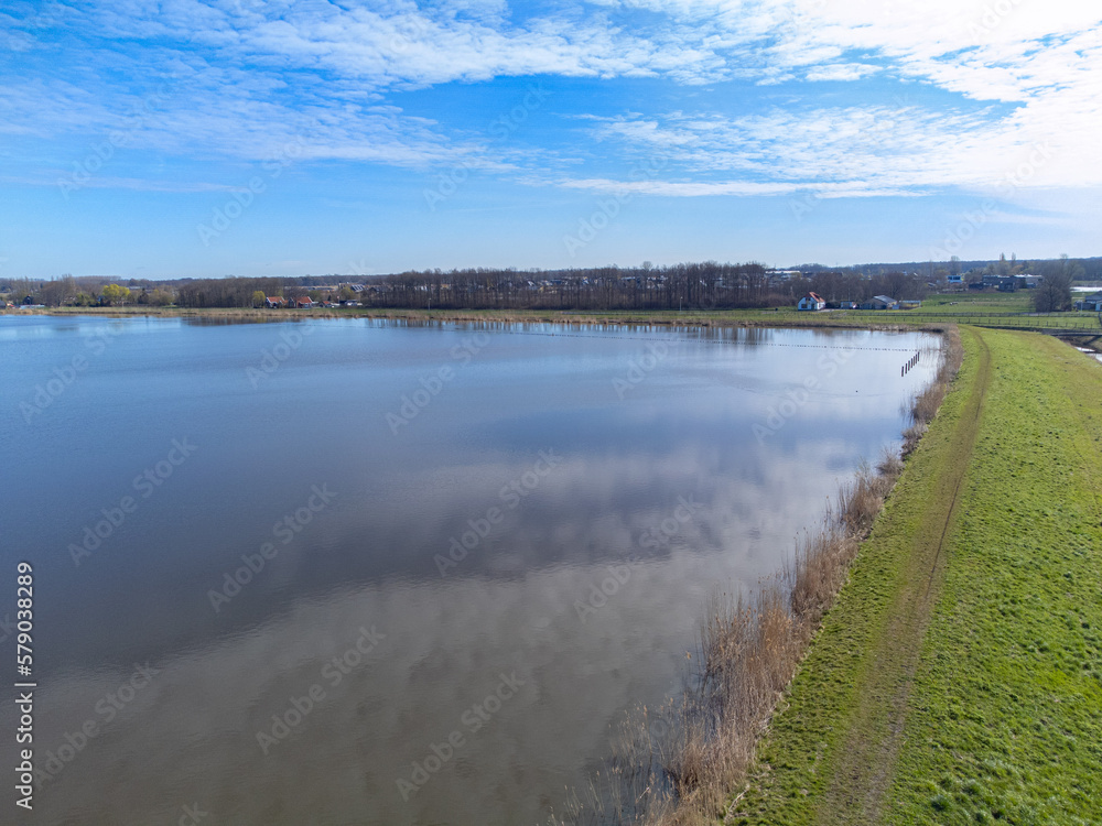 aerial shot above oldambt early spring with sunny wheater with lake, water and blue sky