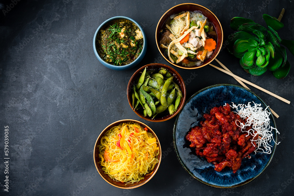 Asian traditional food rice noodles with red pepper, sweet and sour chicken, chicken noodle soup with mushrooms, beans, homemade cheese with spinach and spices. Asian traditional food rice noodles with red pepper, sweet and sour chicken, chicken noodle soup with mushrooms, beans, homemade cheese with spinach and spices.