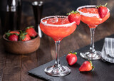 Strawberry margarita cocktail with strawberries and salt rim