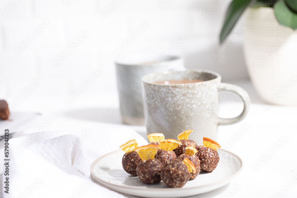 Chocolate protein balls on a white kitchen bench Chocolate protein balls on a white kitchen bench