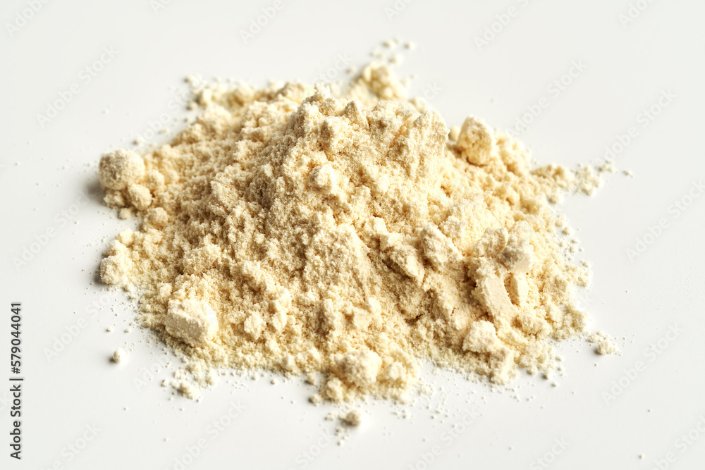 A heap of whey protein powder on white background A heap of whey protein powder on white background