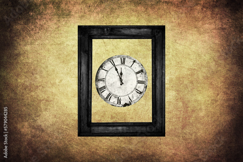 Clock in wooden frame on grungy wall