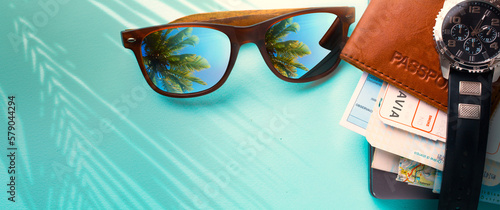 Fototapeta Naklejka Na Ścianę i Meble -  vintage stile concept vacation and Adventure summer travel banner. Happy holidays on tropical sea beach. Passport, air ticketss and sunglasses with a reflection tropical beach palm trees; Copy space