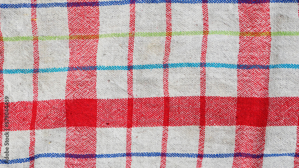 The texture of fabric. Red lines on the fabric. Background The texture of fabric. Red lines on the fabric. Background