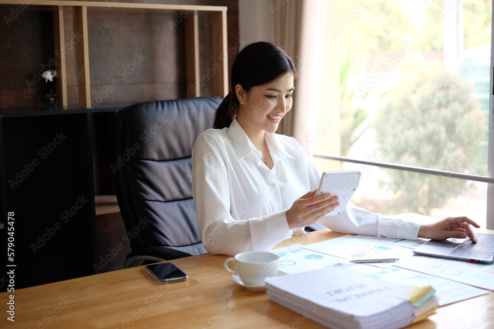 Woman accountant using calculator and computer in office panoramic banner, finance and accounting concept Woman accountant using calculator and computer in office panoramic banner, finance and accounting concept