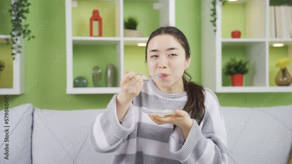 Happy and cute asian young woman eating yogurt.
Young Asian woman eating yogurt at home meets her protein and calcium needs.
Happy and cute asian young woman eating yogurt.
Young Asian woman eating yogurt at home meets her protein and calcium needs.