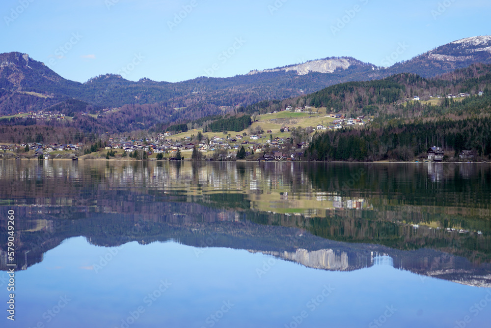 Bad Goisern, Austria - March 2023: Beautiful city view. Mountain Lake. Lake among the mountains. Huts in the mountains near the forest lake.