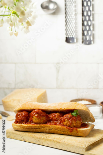 Meatballs sandwich. White background and wooden plate.