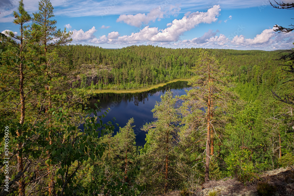 View from Hauklamminvuori Hill to the Hauklampi lake, rocks and forest in the Repovesi National Park on sunny summer day