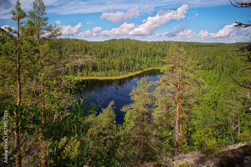 View from Hauklamminvuori Hill to the Hauklampi lake, rocks and forest in the Repovesi National Park on sunny summer day