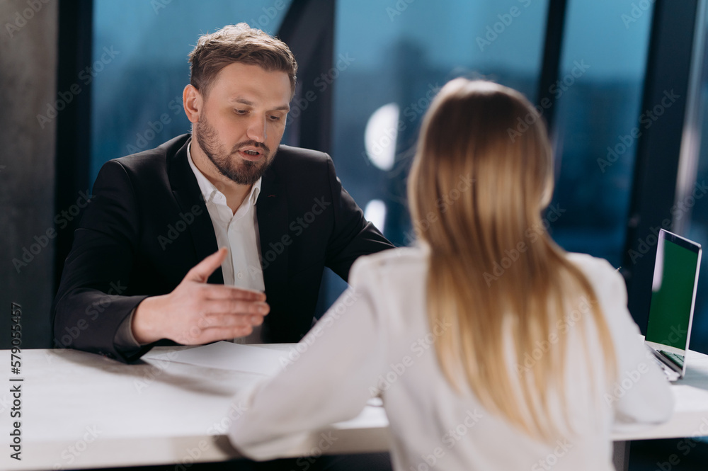 interview of a male and a female in the office. interview in the office. conversation of colleagues interview of a male and a female in the office. interview in the office. conversation of colleagues