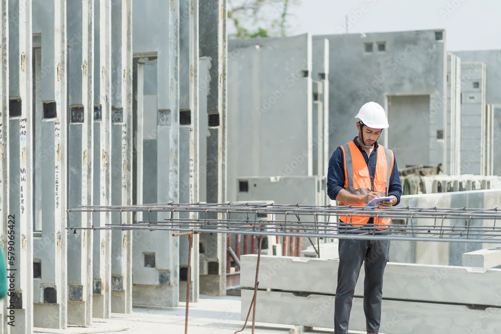 Male engineers are inspecting and controlling the work of the employees and the quality of the manufactured products to meet the standards In industrial factories producing precast prefabricated walls Male engineers are inspecting and controlling the work of the employees and the quality of the manufactured products to meet the standards In industrial factories producing precast prefabricated walls