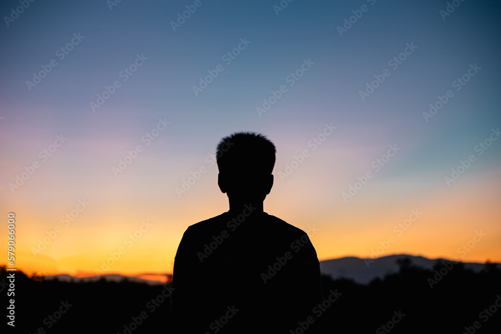 silhouette of a person in the sunset for peaceful and calm concept with copy space.
