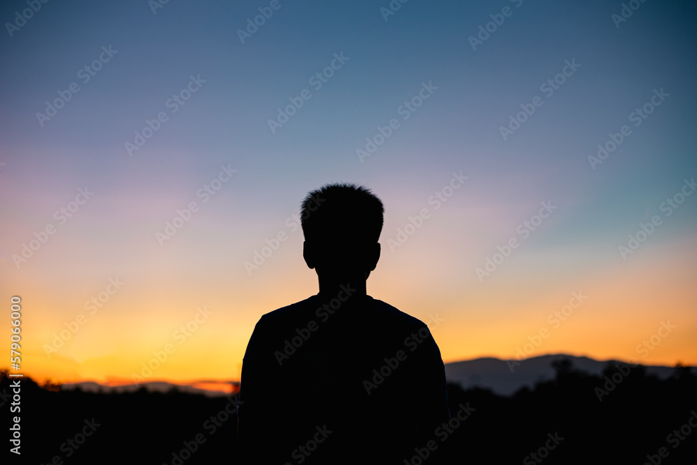 silhouette of a person in the sunset for peaceful and calm concept with copy space. silhouette of a person in the sunset for peaceful and calm concept with copy space.