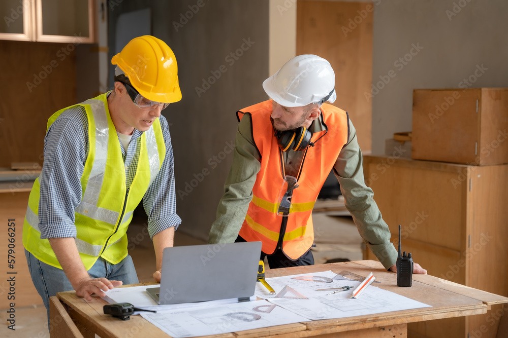Architect caucasian working with colleagues mixed race in the construction site. engineer architect wearing safety helmet meeting at construction site. worker