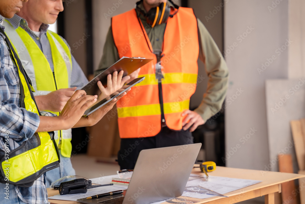 Architect colleagues mixed race working as a team discussing data working and tablet, laptop with on on architectural project. Architect colleagues mixed race working as a team discussing data working and tablet, laptop with on on architectural project.