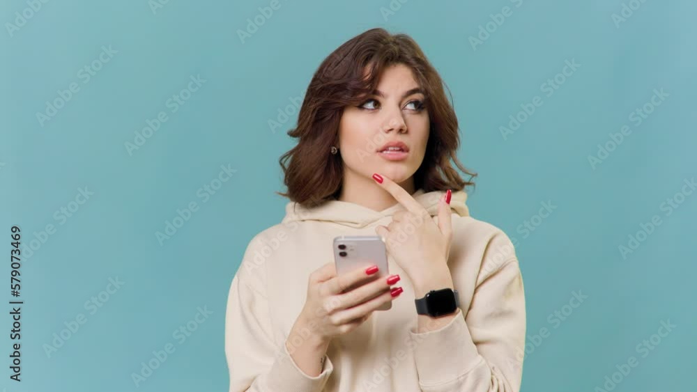 Thoughtful beautiful caucasian girl thinks about something with smartphone, makes decison, Thoughtful beautiful caucasian girl thinks about something with smartphone, makes decison,